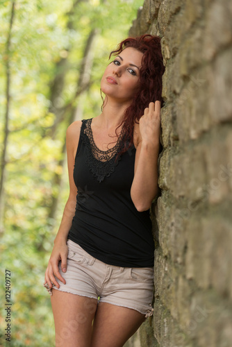 Beautiful young woman with red hair in the park