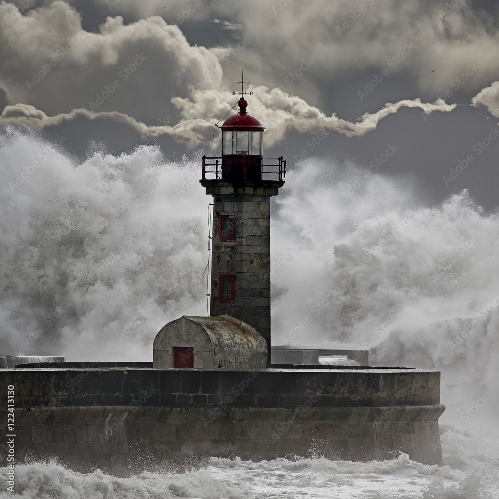 Dramatic stormy waves over lighthouse