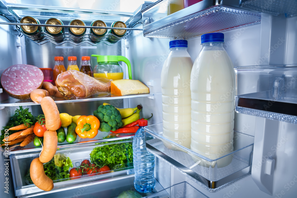 Open refrigerator filled with food Open refrigerator filled with food