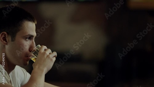 man drinking alcohol in a bar