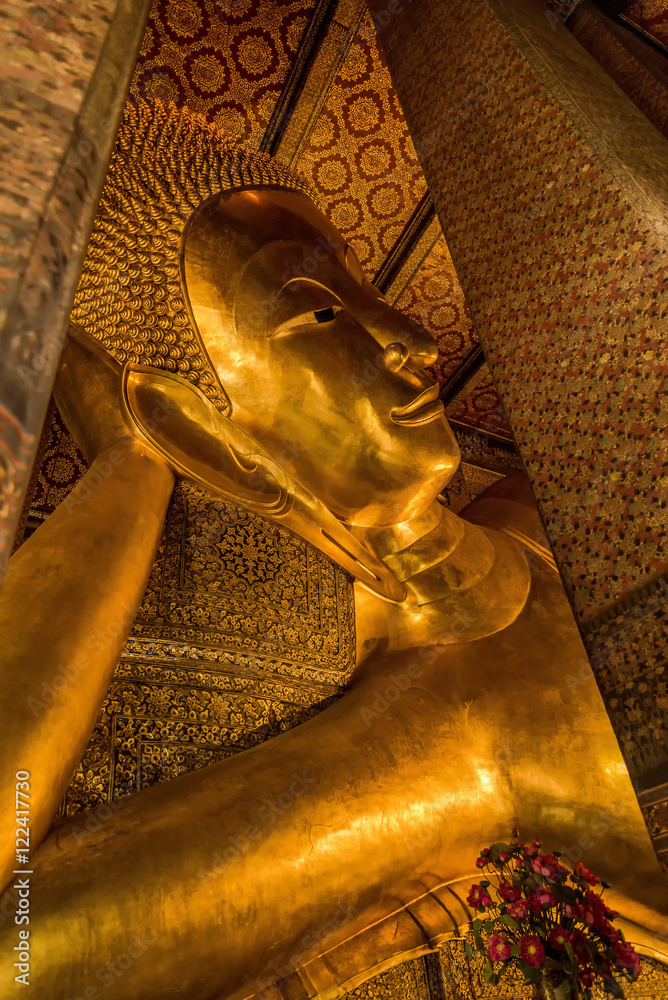 Reclining Buddha gold statue face. Wat Pho, Bangkok, Thailand