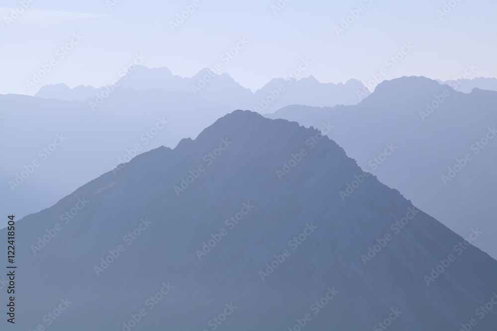mountain silhouette in morning fog