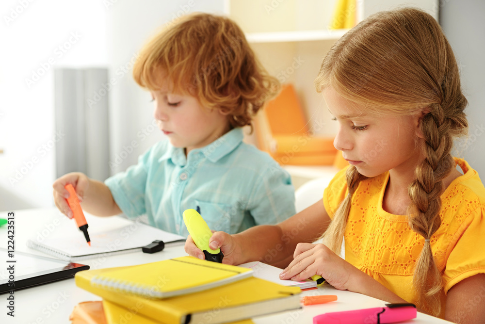 little preschoolers using markers on copybook little preschoolers using markers on copybook
