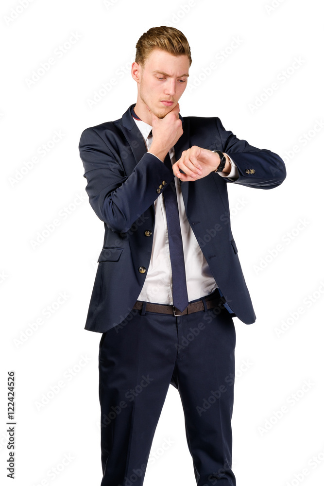 Thoughtful young businessman dressed in a suit looks at watch isolated on white Thoughtful young businessman dressed in a suit looks at watch isolated on white