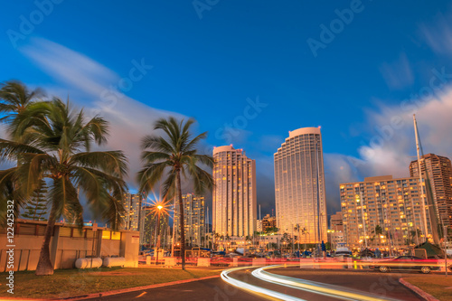 Luxurious hotels overlooking the Ala Wai Harbor at twilight and the light trails in Honolulu, Oahu, Hawaii.