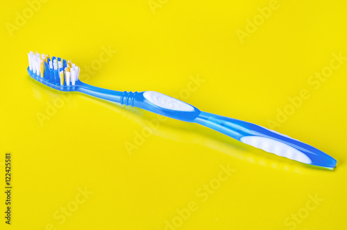 Toothbrush on yellow background