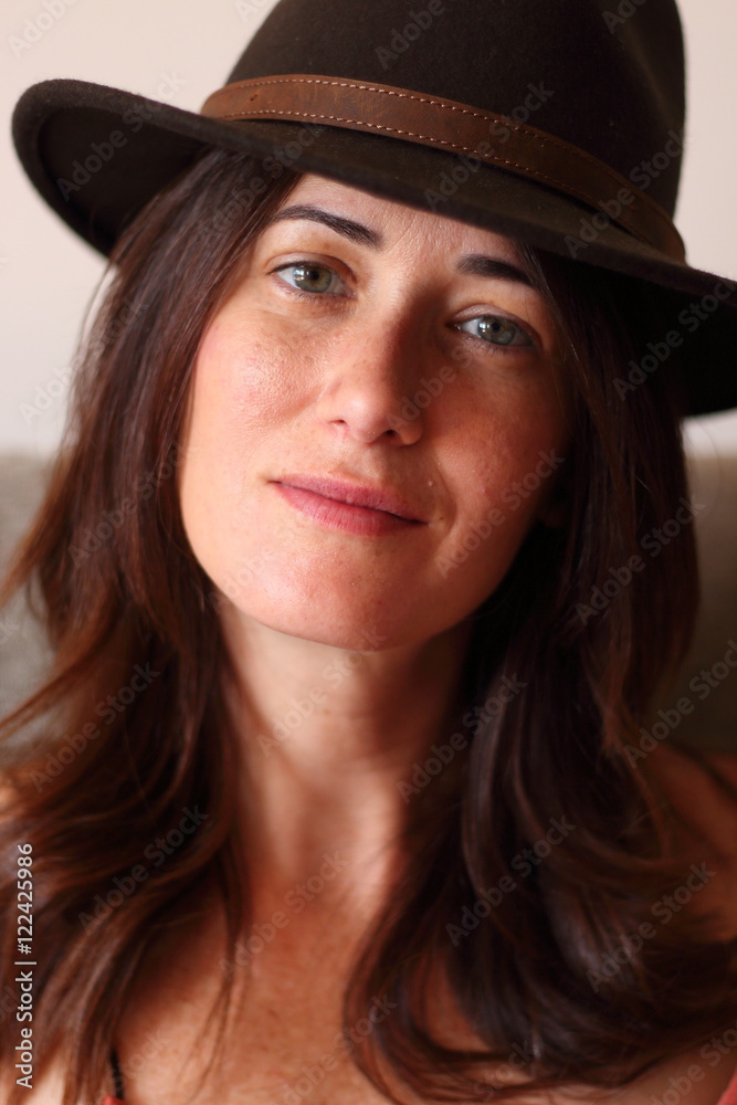 Portrait of a relaxed beautiful woman wearing a stylish hat Portrait of a relaxed beautiful woman wearing a stylish hat