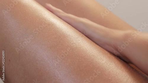 Sensual body cream applying on female tanned legs with hands slow-mo 1920X1080 HD footage - Slow motion woman health care with milky lotion on skin 1080p FullHD video 