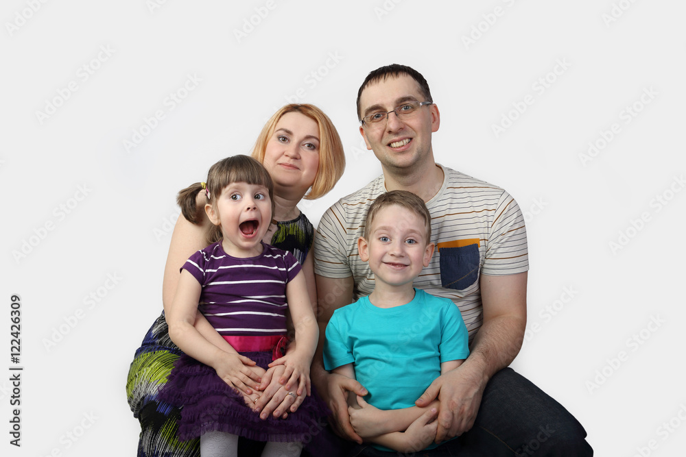 Full family portrait on gray background in square - Man, woman, boy and girl - happy parenthood