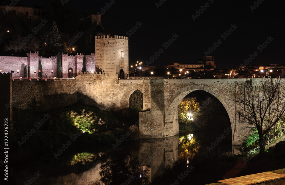Puente romano sobre el rio Tajo (Puente de Alcántara) en Toledo de noche, España