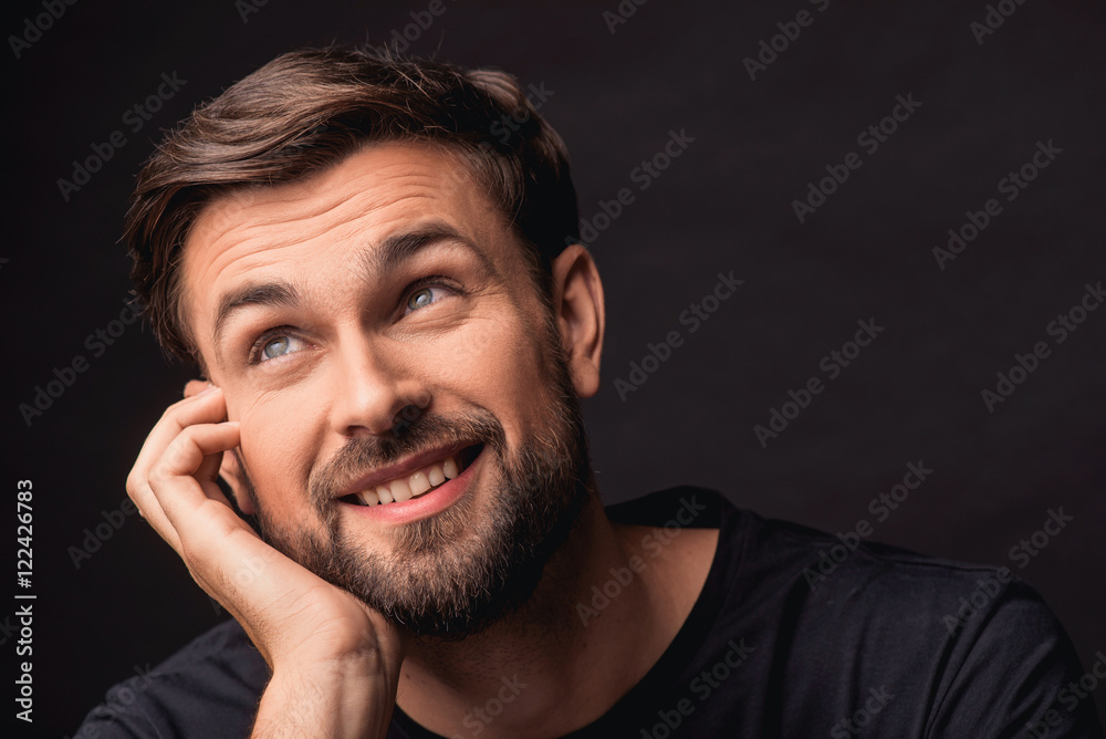 Dreamful guy expressing positive emotions