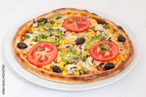 Delicious italian pizza with vegetables & cheese on white plate