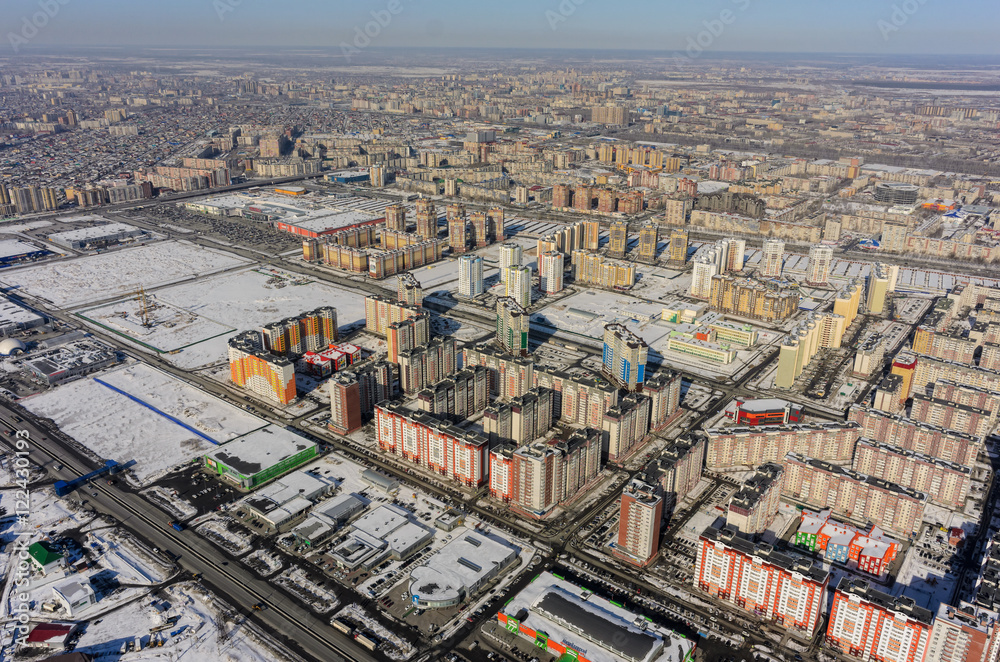 Tyumen, Russia - March 10, 2016: Aerial view on sleeping neighborhood and shopping centers on Fedyuninskogo street