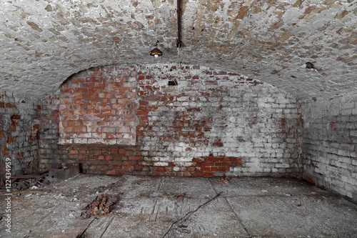 Old abandoned cellar with brick walls and vaulted ceiling - underground