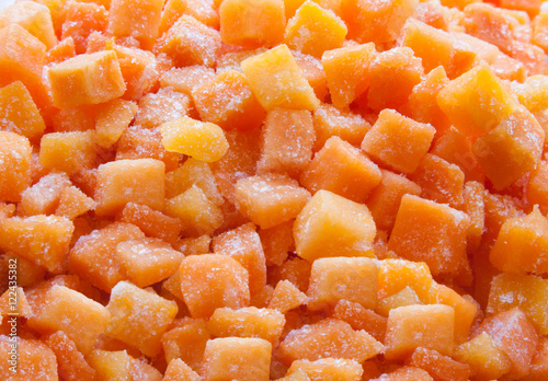 Frozen carrot and pumpkin. Vegetables containing carotene. Background in orange style.