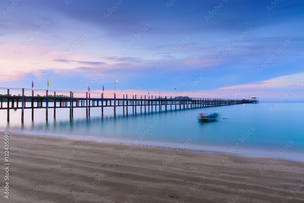 Low light long exposure scenery of a sea with woode bridge,with