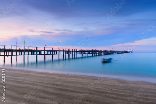 Low light long exposure scenery of a sea with woode bridge with