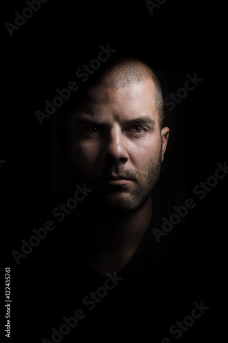 Portrait of young man on a black background