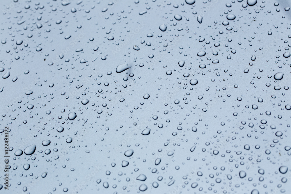 Rain drops on a car hood silver