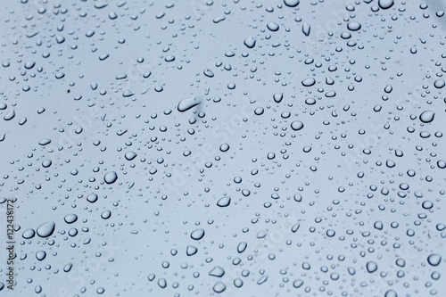 Rain drops on a car hood silver