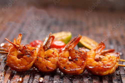 Fresh hot grilled shrimp skewers on the grill