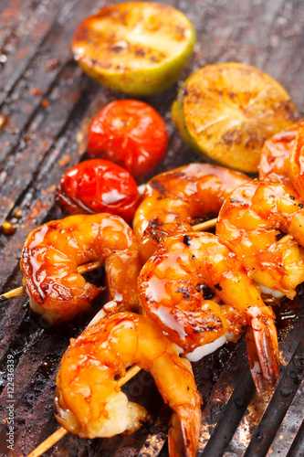 Fresh hot grilled shrimp skewers on the grill