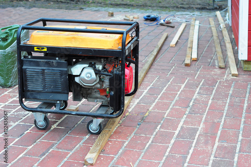Portable Generator with wheels on the House Construction Site.