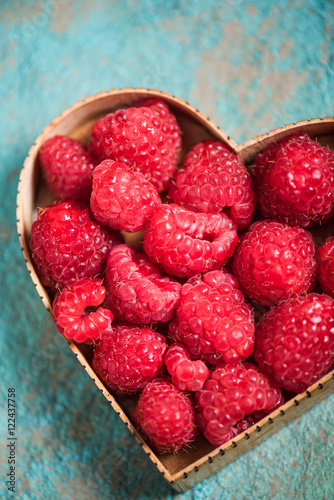 Raspberries in heart shape symbol