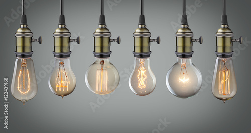 Slika na platnu Vintage hanging light bulbs over gray background