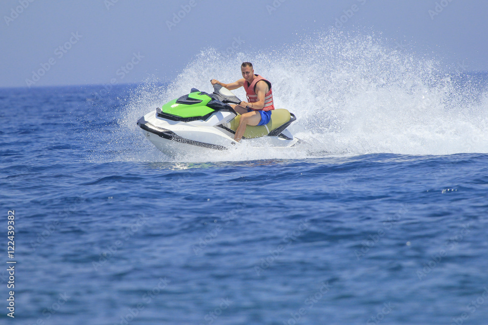 Tourists enjoy driving jetski on the ocean