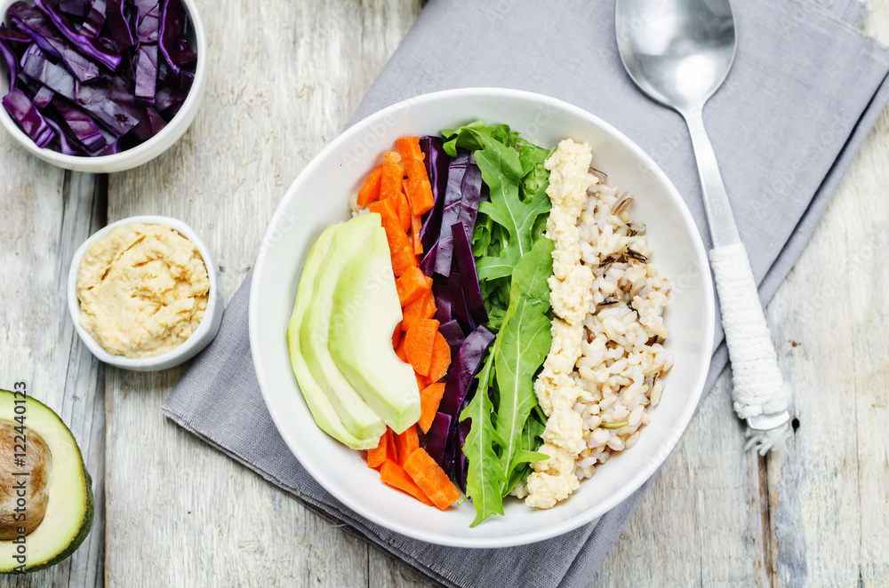Rice bowl with red cabbage, carrots, avocado, arugula and hummus Rice bowl with red cabbage, carrots, avocado, arugula and hummus