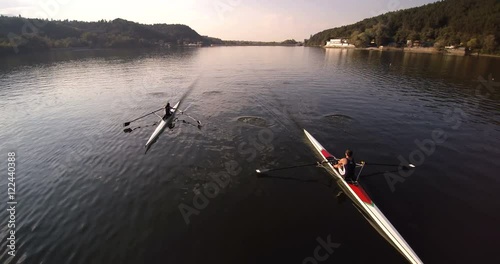 Scull rowing team training. Aerial view, tracking the athletes.  photo