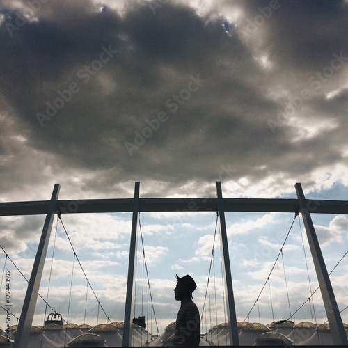 hipster man silhouette in hat on the city street. lonely concept