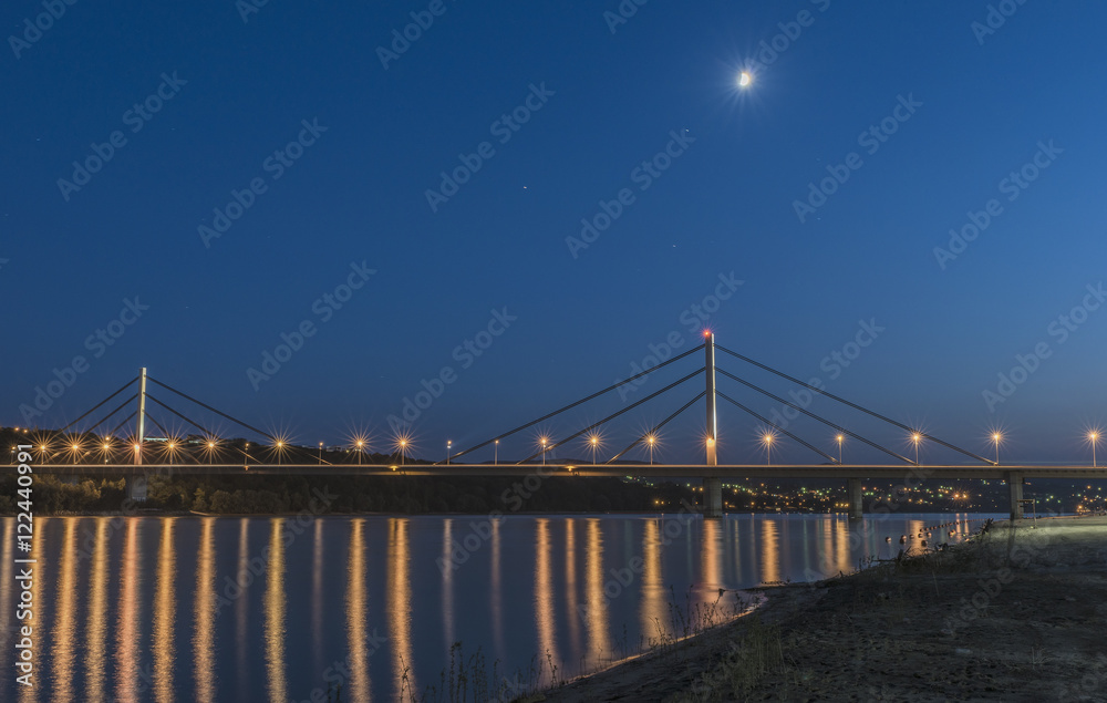 Night image of a road bridge over a wide river