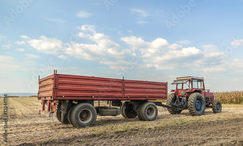 Wallpaper Mural Tractor with trailer standing in a field waiting for harvest Torontodigital.ca