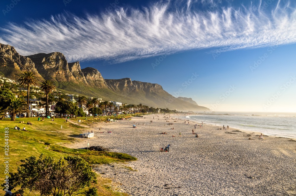 Stunning evening photo of Camps Bay, an affluent suburb of Cape Town, Western Cape, South Africa. With its white beach, Camps Bay attracts a large number of foreign visitors as well as South Africans.