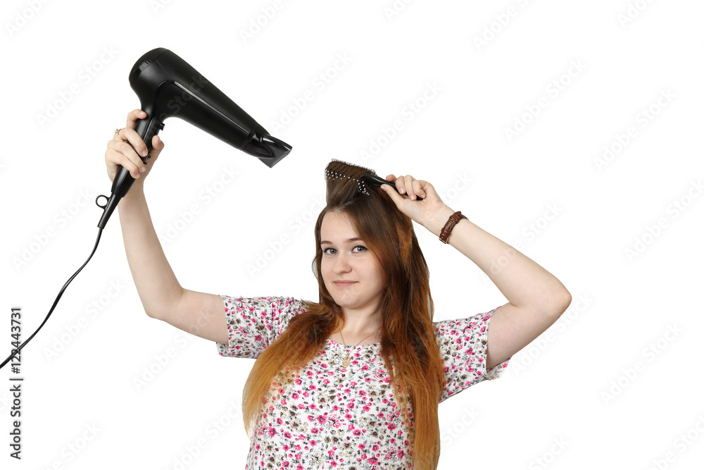 Pretty young girl dries hair by hairdryer isolated on white background - youth make up and beauty Pretty young girl dries hair by hairdryer isolated on white background - youth make up and beauty