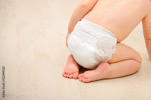 Baby crawling in diaper photo