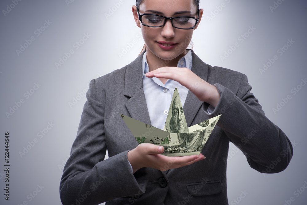 Businesswoman with dollar boats in business concept Businesswoman with dollar boats in business concept