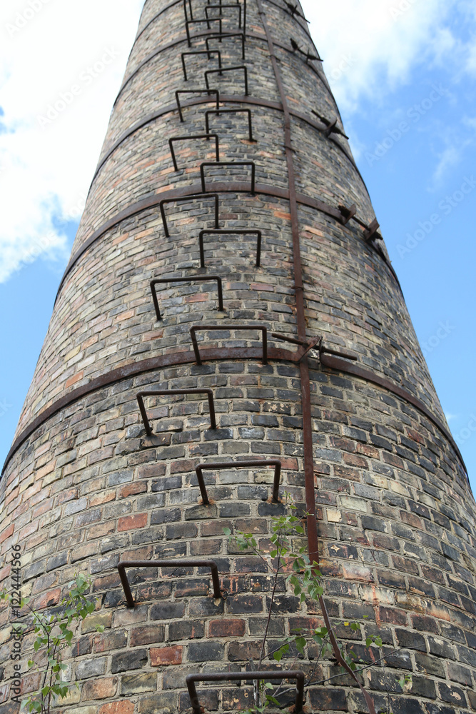 Factory chimney with ladder going to sky