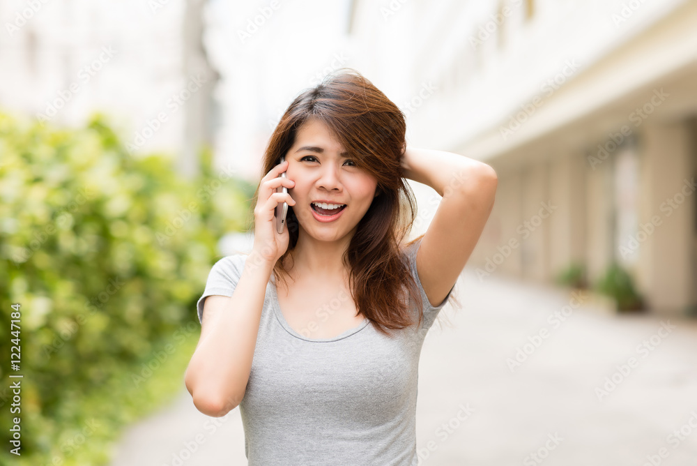 Young asian woman surprised and shocked while talking on smart phone. Young asian woman surprised and shocked while talking on smart phone.