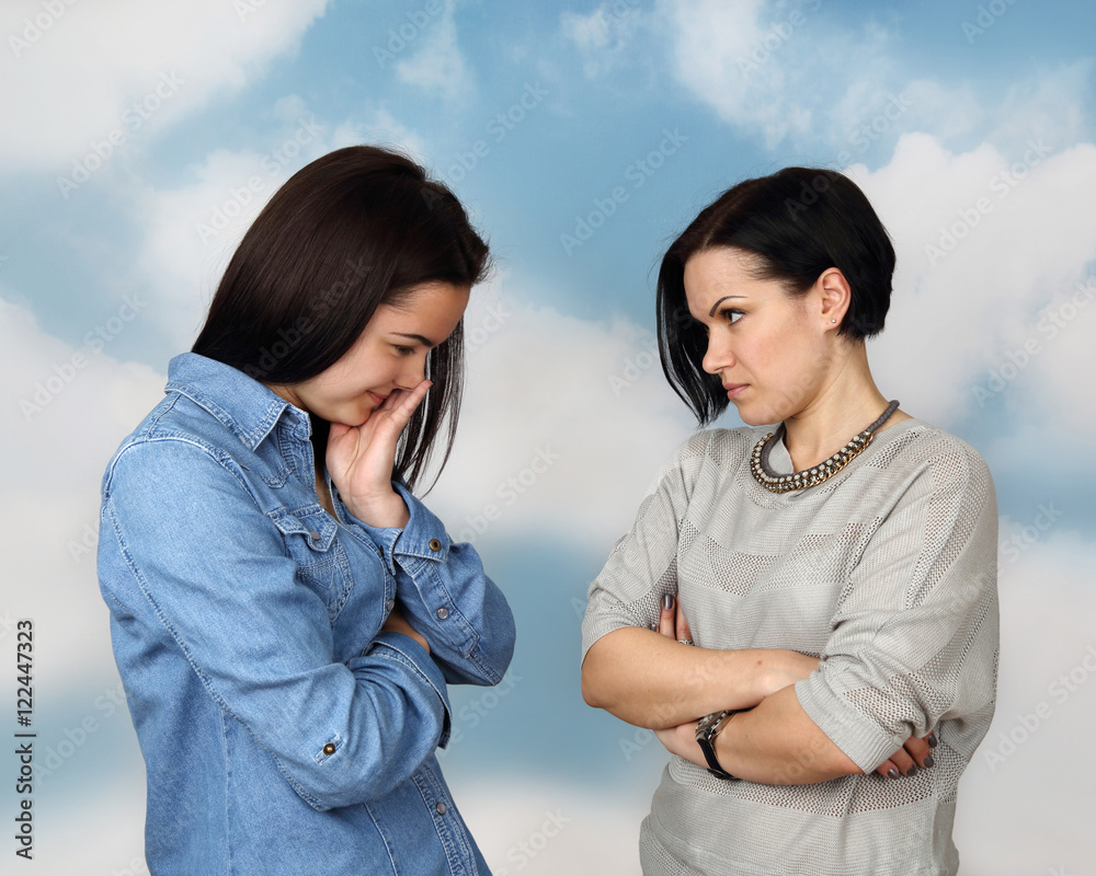 Mother preaches and moralize her teenage daughter on cloudy blue sky background - Family relations, education and parenting concept Mother preaches and moralize her teenage daughter on cloudy blue sky background - Family relations, education and parenting concept