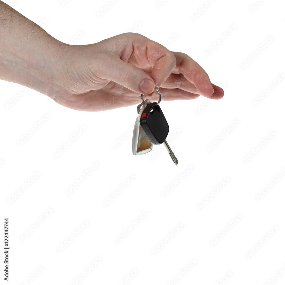 Human hand holds сar key isolated on white background with copy space - means of transportation ownership concept - for advertising of auto trade, lottery or shop