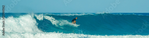 surfer in blue waves in the caribbean