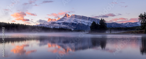 Rundle Mountain reflecting in Two Jack Lake in Banff National Park at sunrise.  photo