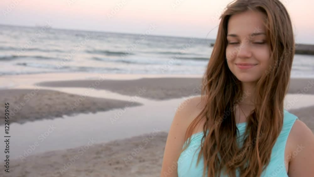 Beautiful girl stays at the beach near sea Beautiful girl stays at the beach near sea