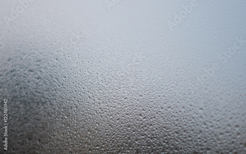 Closeup on fog condensation on window glass background