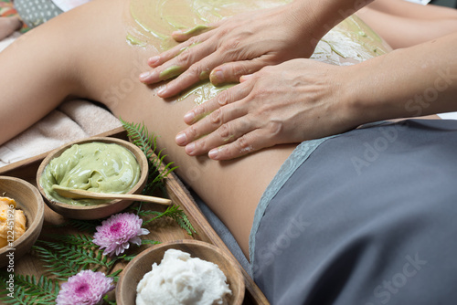 Fototapeta Naklejka Na Ścianę i Meble -  Massage series : Asian woman getting back scrub with green tea in spa