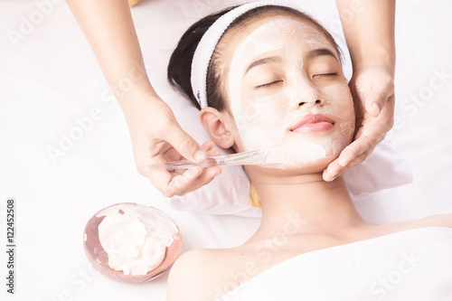 Young girl with facial mask at beauty salon