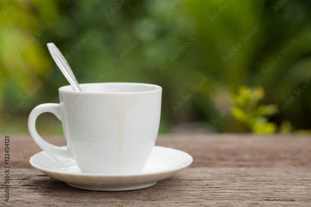Coffee cup with coffee stains edge on wooden in the backyard Nat Coffee cup with coffee stains edge on wooden in the backyard Nat
